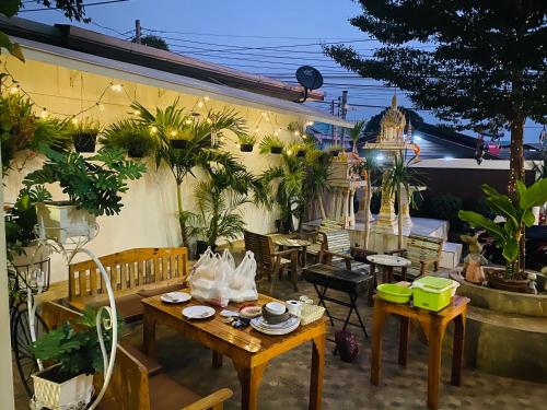 a patio with tables and chairs and plants at Kohlarn Resort in Ko Larn