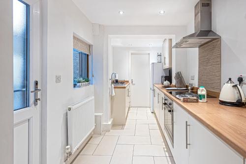 a kitchen with white cabinets and a counter top at Taitwt1 in Caernarfon