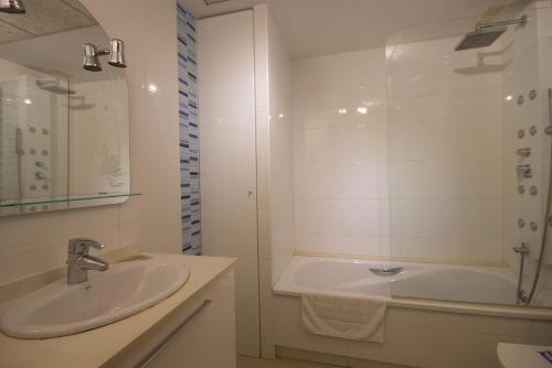 uma casa de banho com um lavatório, um chuveiro e uma banheira em Style Apartment Patacona Beach segunda linea em Valência