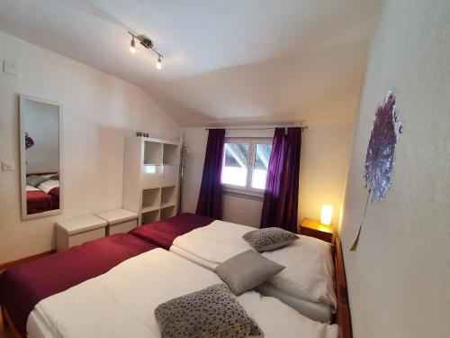 a bedroom with two beds and a window at Ferienwohnungen Wallis - Randa bei Zermatt in Randa