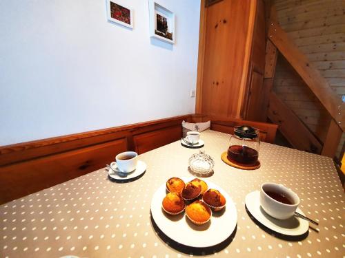 two plates of pastries and cups on a table at Ferienwohnungen Wallis - Randa bei Zermatt in Randa