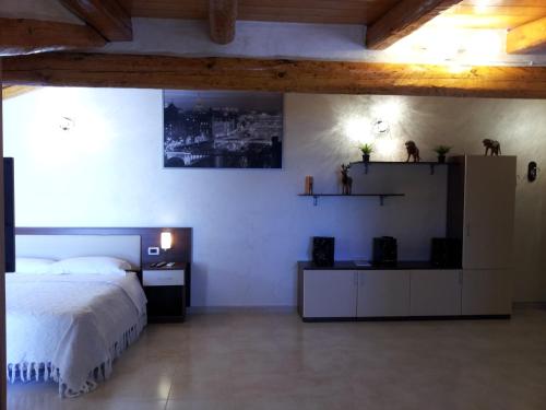 a bedroom with a bed and a desk and shelves at B&B Suite in Viagrande