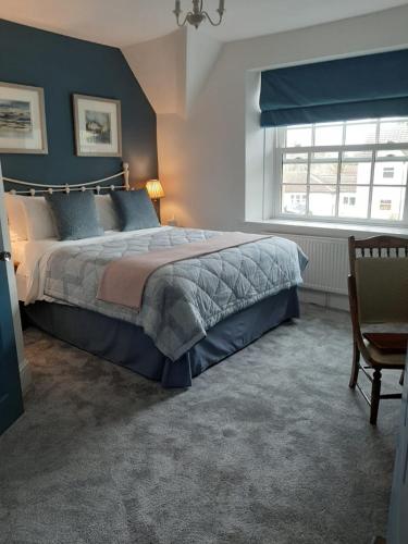 a bedroom with a large bed and a window at The Bell at Old Sodbury in Chipping Sodbury