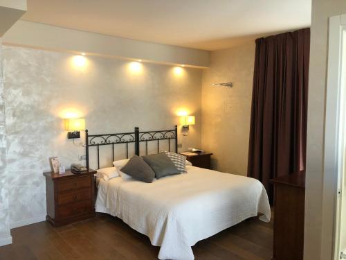 a bedroom with a bed with two pillows on it at Hotel Ferro di Cavallo in Pavullo nel Frignano