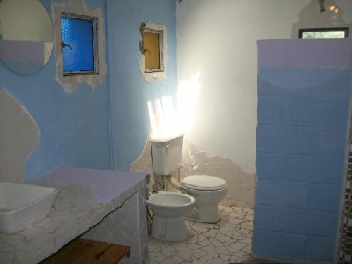 baño con 2 aseos y lavamanos en Hosteria Aura Azul (ex Ser Azul) en Capilla del Monte