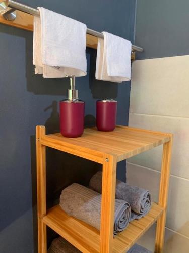 a wooden shelf with towels and a lamp in a bathroom at Private jungle “Loft del Rio” river access in Uvita