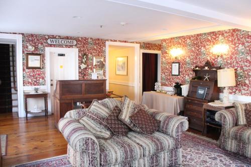 a living room with a couch and a table at Old Orchard Beach Inn in Old Orchard Beach