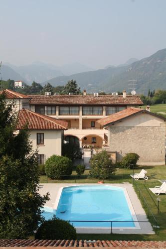 a large house with a swimming pool in front of it at Il Colombaro in Salò