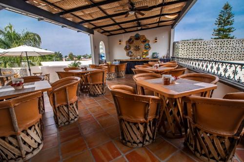 a restaurant with wooden tables and chairs at Puerta San Pedro in Guadalajara