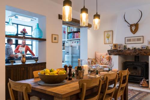 una cucina con tavolo in legno e cesto di frutta di Casa Higueras a Moclín