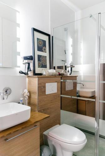 a bathroom with a toilet and a sink at Matik Apartamenty i pokoje in Karwia
