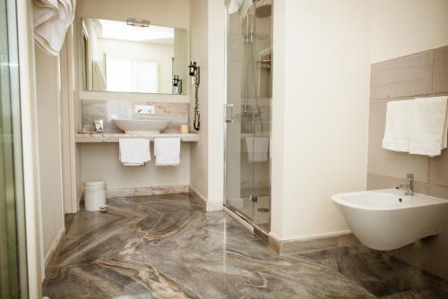 a bathroom with a sink and a toilet and a shower at La Castellana in Fosdinovo