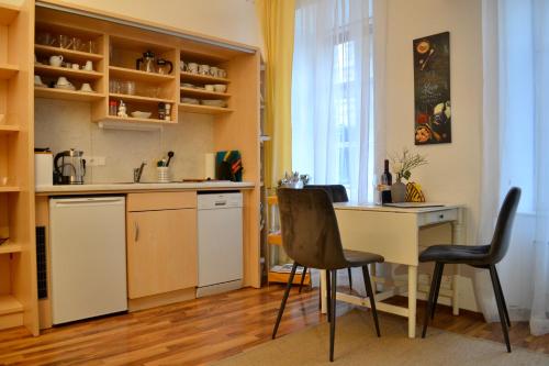 a kitchen with a table and two chairs in a room at City-Maisonette in Vienna