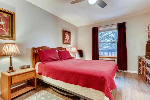 a bedroom with a red bed and a window at Mountainside #272H in Frisco