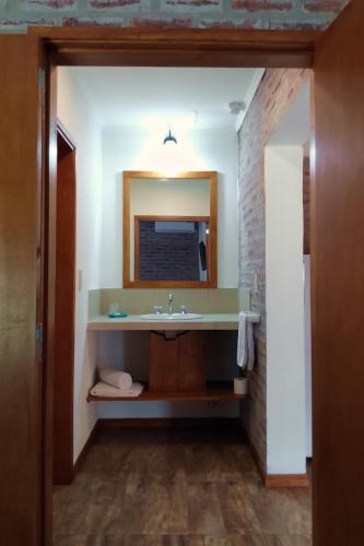 a bathroom with a sink and a mirror at Las Arecas in Carmen de Areco