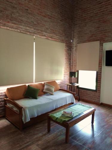 a bedroom with a bed and a coffee table at Las Arecas in Carmen de Areco