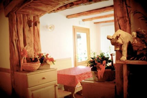 a bedroom with a dresser with potted plants on it at Agriturismo Plan Da Crosc in Prato Carnico