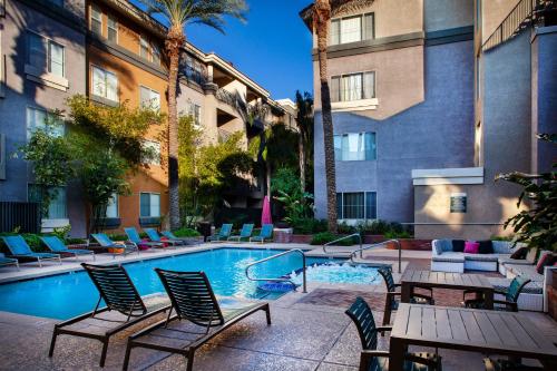 a pool with chairs and tables in a hotel courtyard at Luxury Condos by Meridian CondoResorts- Scottsdale in Scottsdale