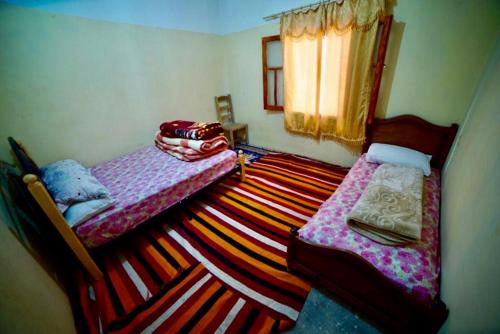 Кровать или кровати в номере Dar Almanadir Todra