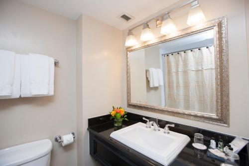 a bathroom with a sink and a mirror at Old Stone Inn Boutique Hotel in Niagara Falls