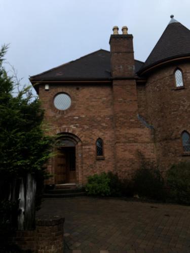 an old brick building with a door and a chimney at Tower House in Crawfordsburn