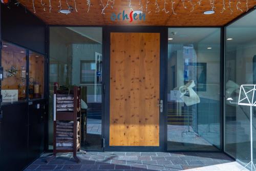 a wooden door of a store with glass windows at Boutique Hotel OchSen Self-Check-In in Bad Ragaz
