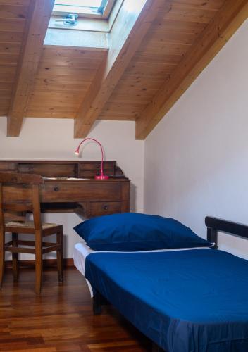 a bedroom with a bed and a desk at The Gulf Villa - Lago Maggiore in  Monvalle 