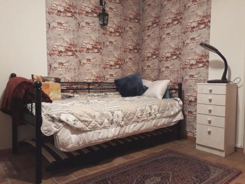 a bedroom with a bed and a wall with a dresser at One-bed room Mariensee in Neustadt am Rübenberge