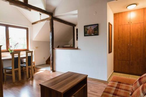 a living room with a table and a dining room at Penzion U Holuba in Hradčovice