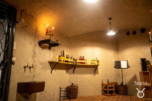 a room with a shelf on the wall with candles at Boutique Hotel OchSen Self-Check-In in Bad Ragaz