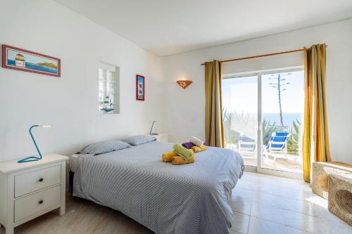 a bedroom with a bed with a stuffed animal on it at Apartment Isabel in Carvoeiro