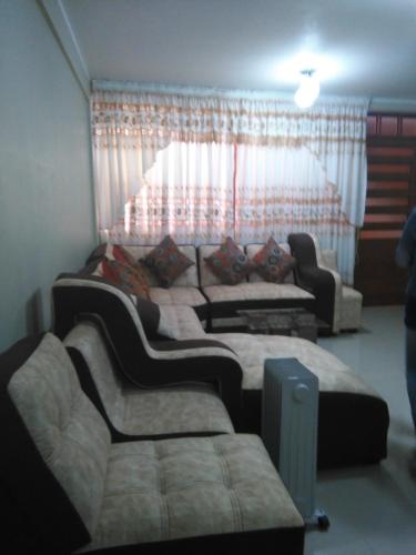 a living room with three beds and a couch at PYMABET in Huancavelica