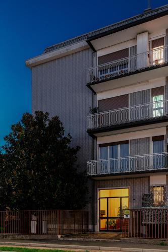 a tall building with a window and a balcony at Anjoy&Bleev Rooms in Rho