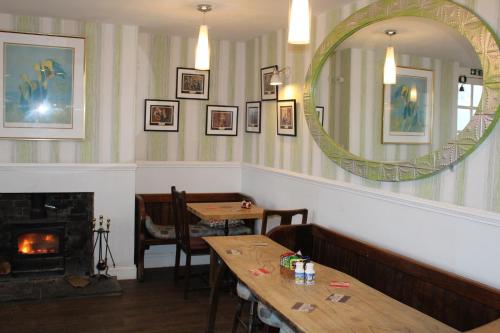 a mirror in a restaurant with a table and a fireplace at The Old Red Lion in Thame