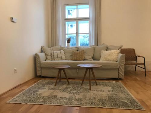 a living room with a couch and two tables at Stará Škola Hedeč in Králíky