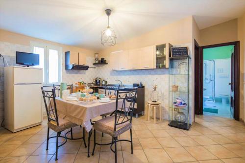 a kitchen with a table and chairs and a refrigerator at Traulivi country house in Meta