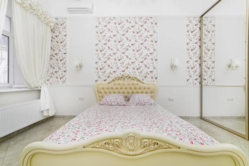 a white bedroom with a bed with pink bedding at NEW!Designer apartment on Deribasovskaya in Odesa