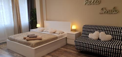 a small bedroom with a bed and a couch at Bsuites Scrovegni in Padova