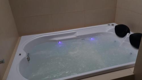 a bath tub with two speakers in a bathroom at Chalé Caminho da Fonte in Monte Verde