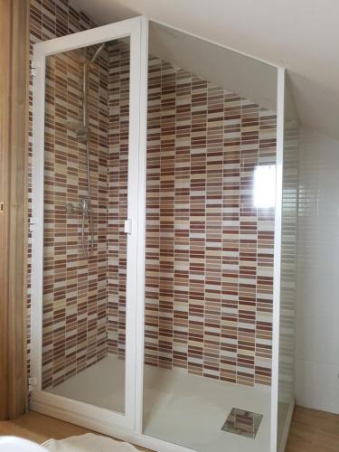 a bathroom with a shower with wooden blinds at Apartamento en zona rustica de Camariñas in Camariñas