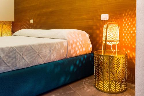 a bedroom with a bed and a lamp on a table at ROSAMIMAMA citra OO9042-LT-0250 in Voze