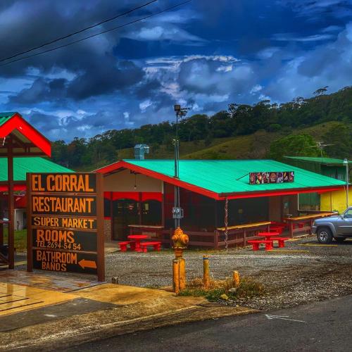 a building with a green roof and a fire hydrant at Habitaciones el corral in Aguacate