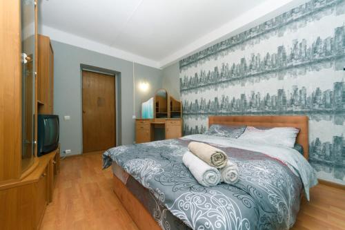 a bedroom with a bed with towels on it at 1 комнатная квартира м Васильковская газ и низкий этаж in Kyiv