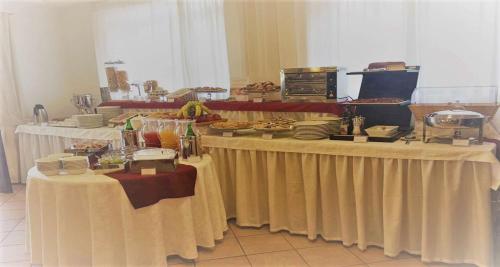 a long table with food and plates on it at Best Western Hotel La Conchiglia in Palinuro