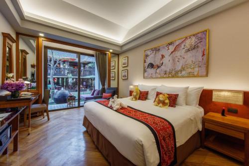 a hotel room with a bed and a large window at Chala Number6 in Chiang Mai