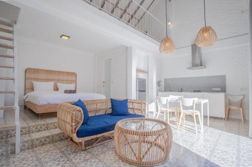 a bedroom with a bed and a table and chairs at White Studio, villa with private pool Canggu in Canggu