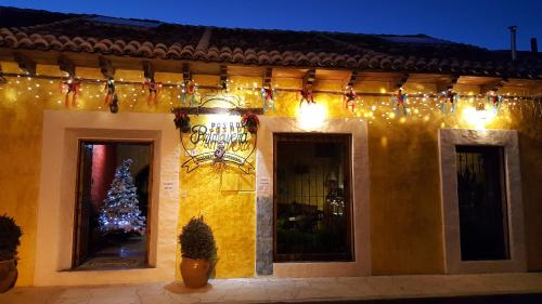 a building with christmas lights and a christmas tree at Hotel Posada Primavera in San Cristóbal de Las Casas