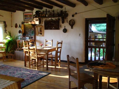 uma sala de jantar com uma mesa e cadeiras num quarto em Old Taos Guesthouse B&B em Taos