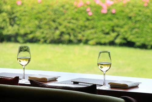 two glasses of white wine sitting on a table at Soratoniwa Atami Izusan in Atami
