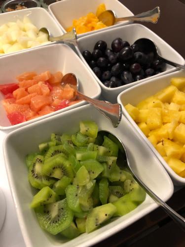 a tray filled with bowls of fruit and vegetables at Hotel Lippischer Hof in Detmold